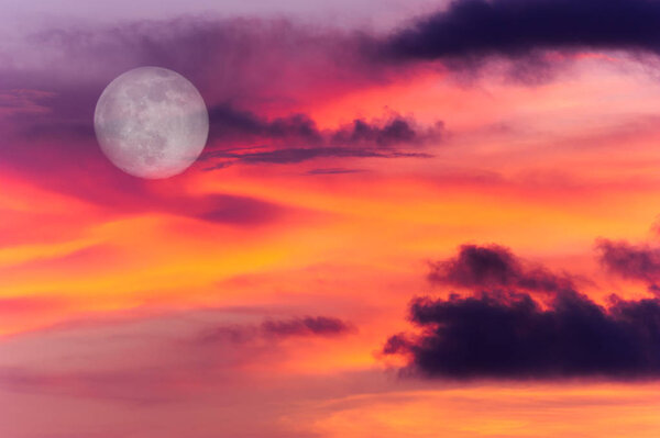 Moon clouds is a colorful surreal fantasy like pink and blue cloudscape with a magical surreal full moon rising in the night sky.