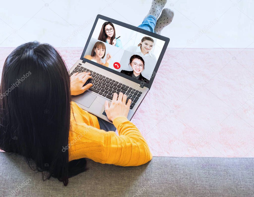 Laptop screen view over business woman talking about work,sitting by sofa make video call have distant communication using videoconference app working from home to prevent corona virus