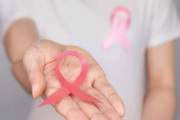 World Breast Cancer Day Concept,health care - woman wore white t-shirt,Pink ribbon for breast cancer awareness, symbolic bow color raising awareness on people living with women's breast tumor illness