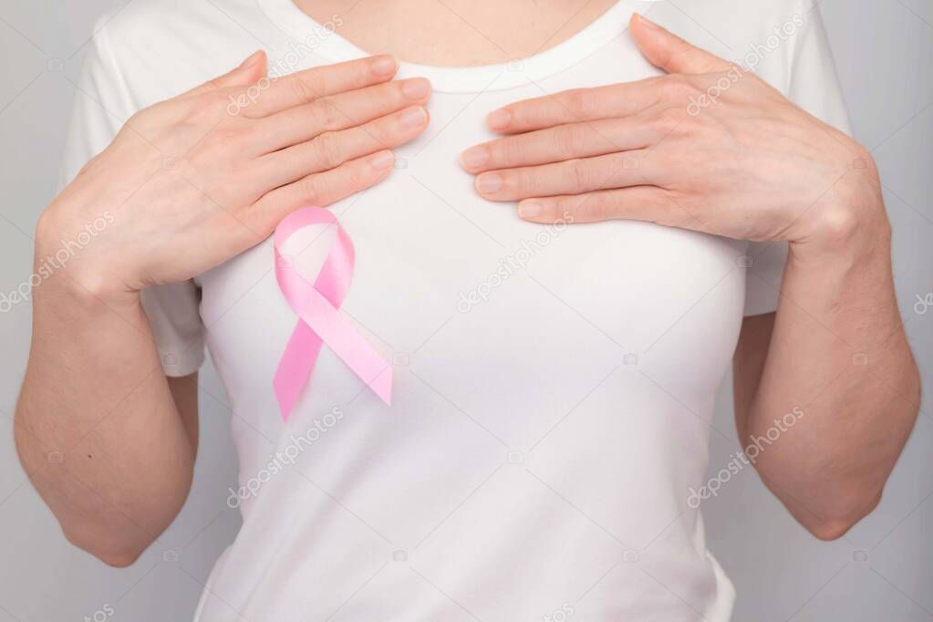 World Breast Cancer Day Concept,health care - woman wore white t-shirt,Pink ribbon for breast cancer awareness, symbolic bow color raising awareness on people living with women's breast tumor illness