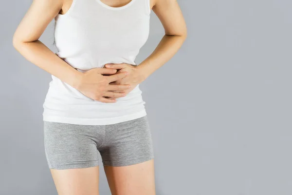 Young Woman White Undershirt Gray Shorts Grabbing Belly She Have — Stock Photo, Image