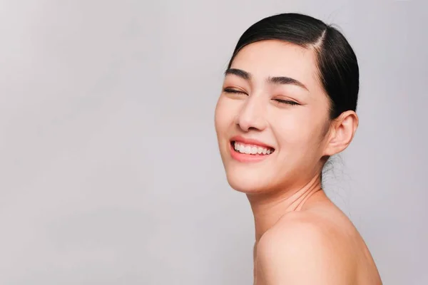 きれいな 新鮮で明るい肌を持つ若い美しいアジアの女性 幸福と肯定的な感情で陽気です 灰色の背景に隔離されました 美容化粧品と顔の治療の概念 — ストック写真