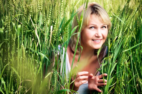 Woman in wheat field Stock Picture