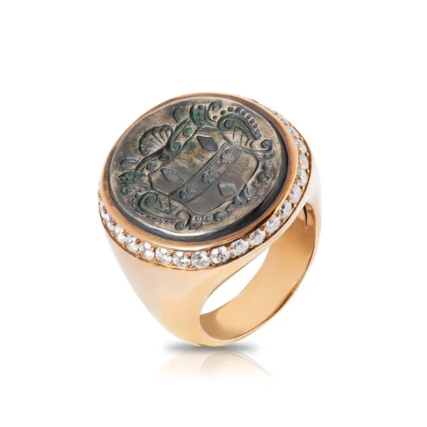 Pink signet ring with diamonds inlaid with an old coin isolated on white background