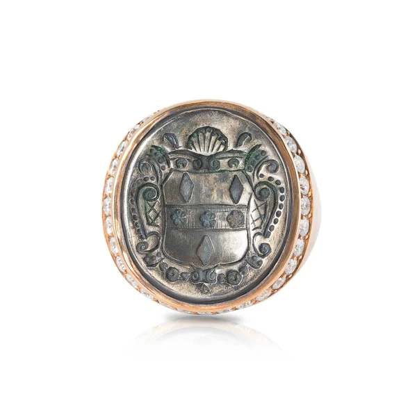 Pink signet ring with diamonds inlaid with an old coin isolated on white background