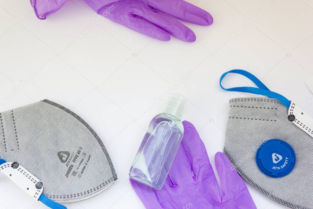 Coronavirus personal protective equipment concept with copy space. Medical latex gloves, goggles, ffp2 respirator, antibacterial gel.coronavirus flatly.