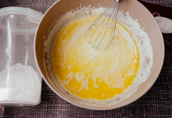 Dough for making pancakes or omelet in a bowl with a whisk in the kitchen.homemade healthy pancakes made from cottage cheese. pancakes instruction step by step.step 1 making dough for pancakes.