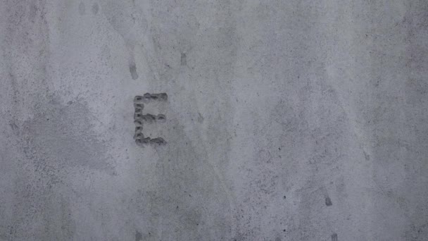 Bullet Hits Concrete Wall Spelling Word End — Stock Video