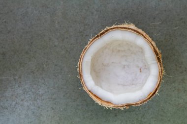 Sade gri taştan arka planda yarım kesilmiş hindistan cevizi görünümü