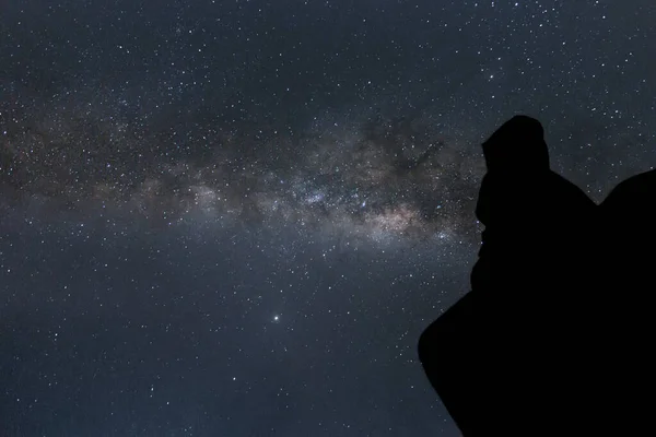 silhouette of person gazing the galactic center of the milky way