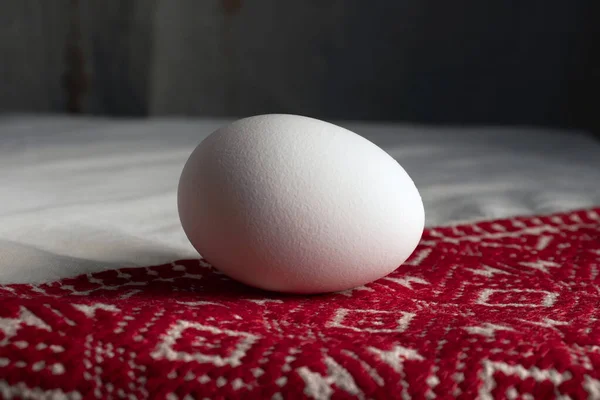 Easter egg on a patterned tablecloth