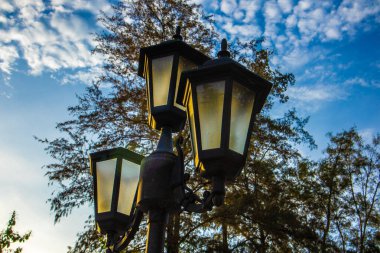 Üç eski lamba ve karanlık gökyüzü