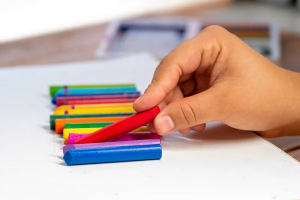 Girl Hand Picks Red Wax Crayon Many Colors Background — Stock Photo, Image
