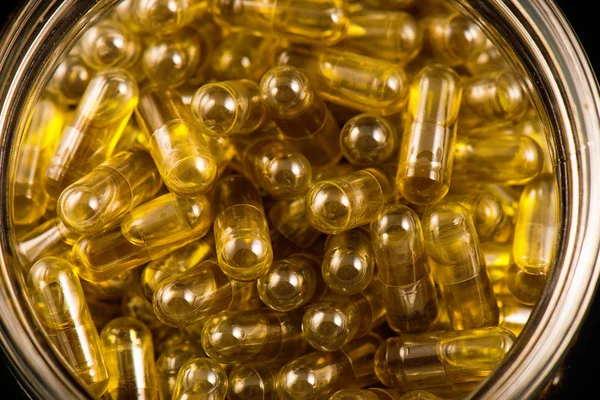 Cannabis extraction capsules infused with shatter on a glass jar — Stock Photo, Image