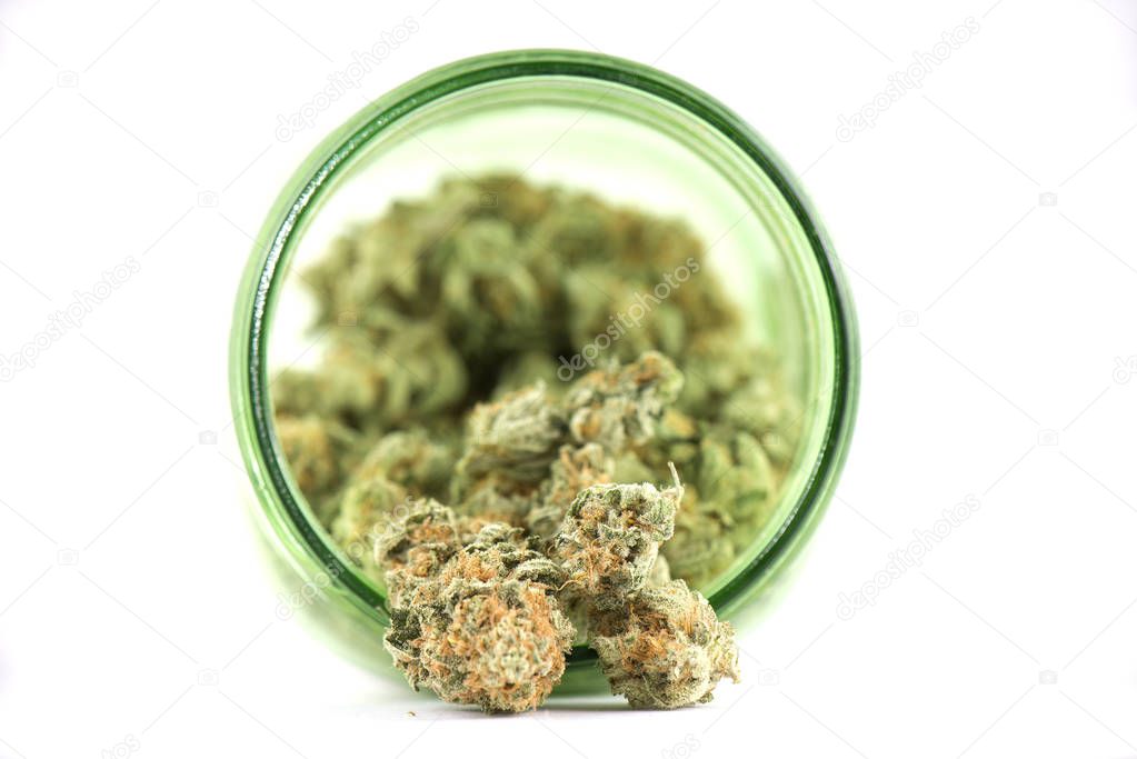 Detail of cannabis buds (mango puff strain) on green glass jar i