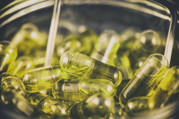 Cannabis extraction capsules infused with CBD oil in a jar — Stock Photo, Image