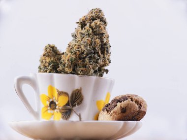 Detail of cannabis nug and coffee cup with chocolate chip cookie clipart