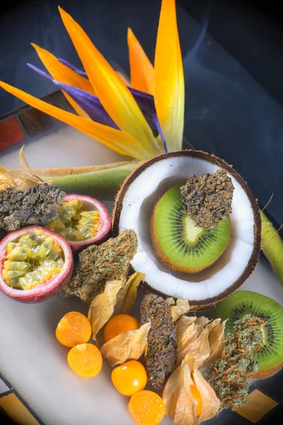 Assorted dried cannabis buds with fresh tropical fruit - medical — Stock Image Assorted dried cannabis buds with fresh tropical fruit - medical Stock Photo