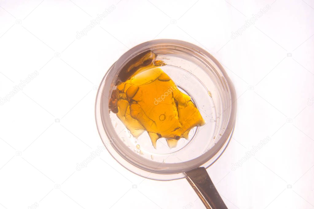 Piece of cannabis oil concentrate aka shatter used by medical ma