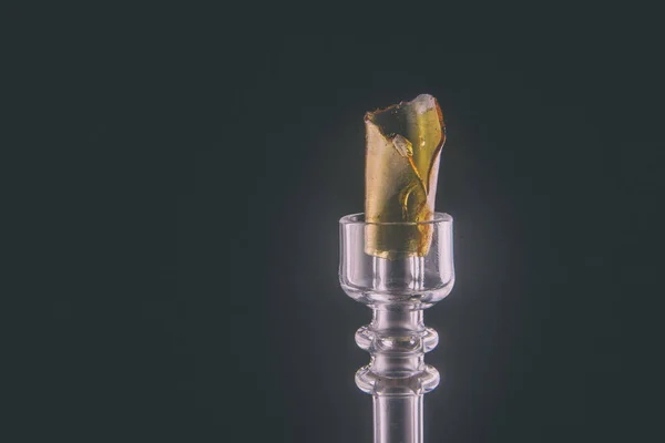 Cannabis resin aka shatter on glass rig isolated over black — Stock Photo, Image