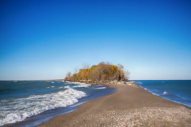 Tip of Point Pelee National Park beach in the fall at sunset tim clipart