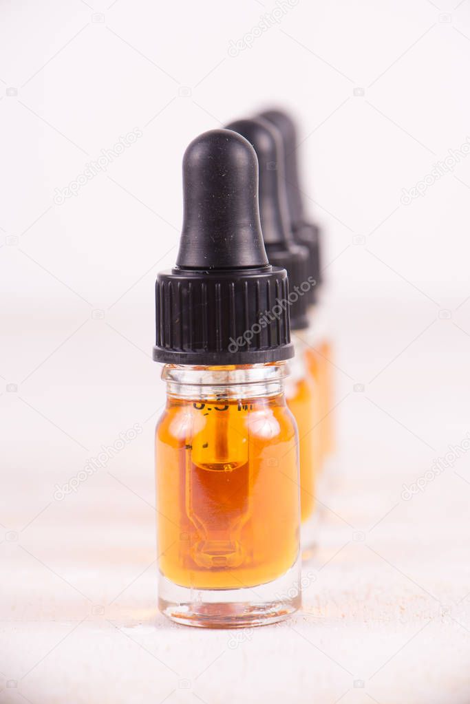 Vials of CBD oil, cannabis live resin extraction isolated on whi