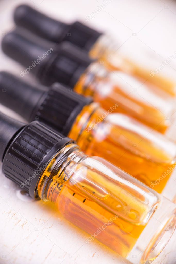 Vials of CBD oil, cannabis live resin extraction isolated on whi