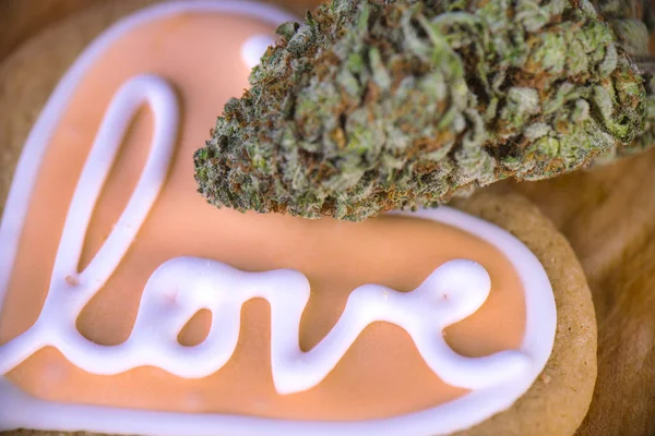 Dried cannabis nug with baked cookies on a wood tray — Stock Photo, Image