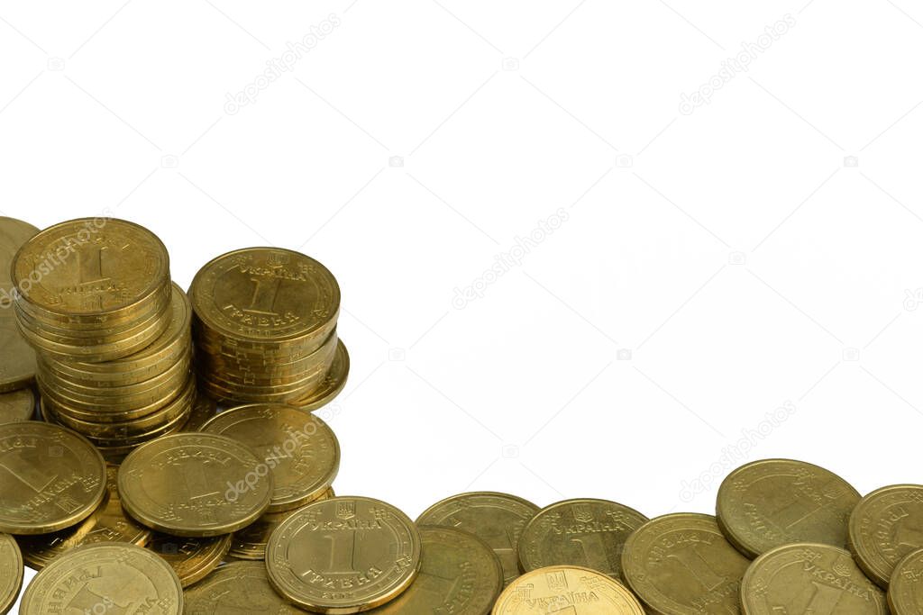 Scattered yellow iron coins and in stacks on a white background