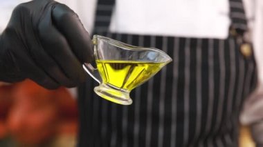 Şef etin üzerine zeytinyağı döker.