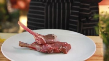 Aşçı tabağa çiğ et koyar.