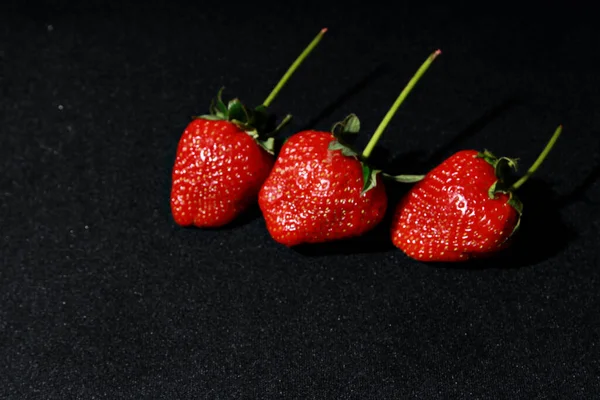 strawberries on a black background