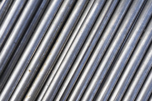 industrial background. cylindrical metal details on grey background