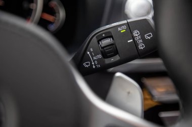Modern premium lüks bir arabada sileceklerin kontrol düğmeleri olan çok fonksiyonlu dönüş sinyal kolunun yakın plan görüntüsü. Yakın plan, yumuşak odak, bulanık arkaplan