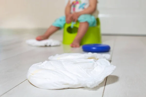 Clean Diaper Lying Bright Floor Background Child Sitting Green Pot — Stock Photo, Image