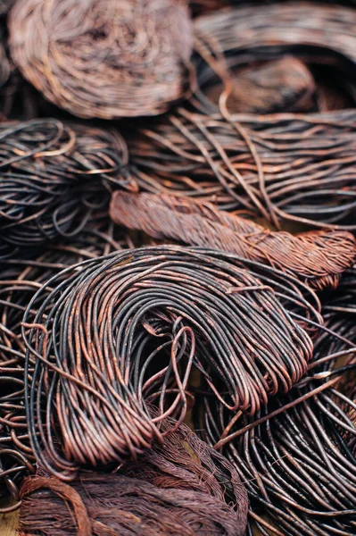 Copper scrap metal, wire, windings of motors and transformers, electrical wire without insulation. Calcined oxidized copper wire. Against the background of a copper sheet. Close-up. Macro.