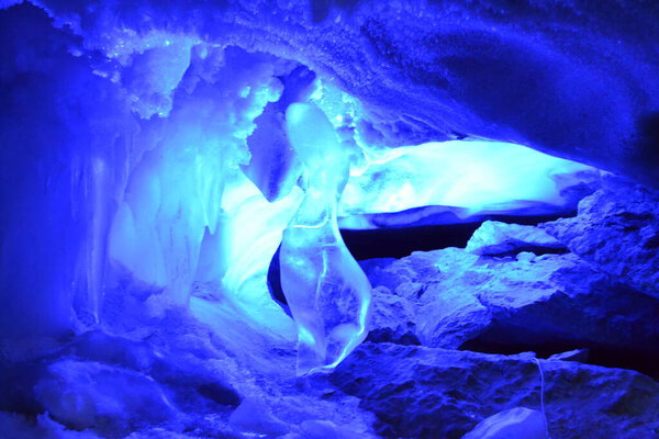 In an ice cave, bizarre forms of ice are surrounded by snow, which is formed due to low temperatures and high humidity. The blue backlight creates a unique visual experience forcing you to plunge into the vast waters of your own imagination