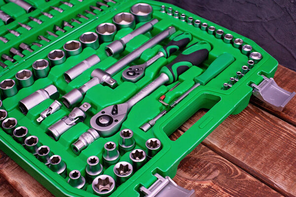 Car maintenance and repair concept. Tool set made of stainless chrome steel on a gray industrial background. screwdriver, wrench, spanner.