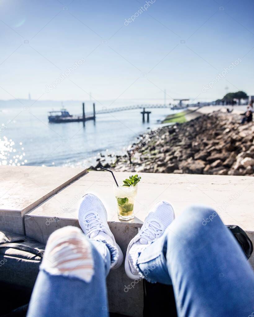 Cold gin and tonic on a deck chair by the river, Lisbon