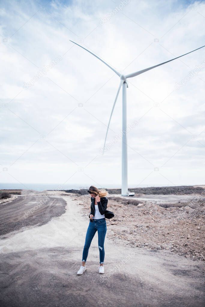 Girl on an abandoned road to the wind turbine, Tenerife