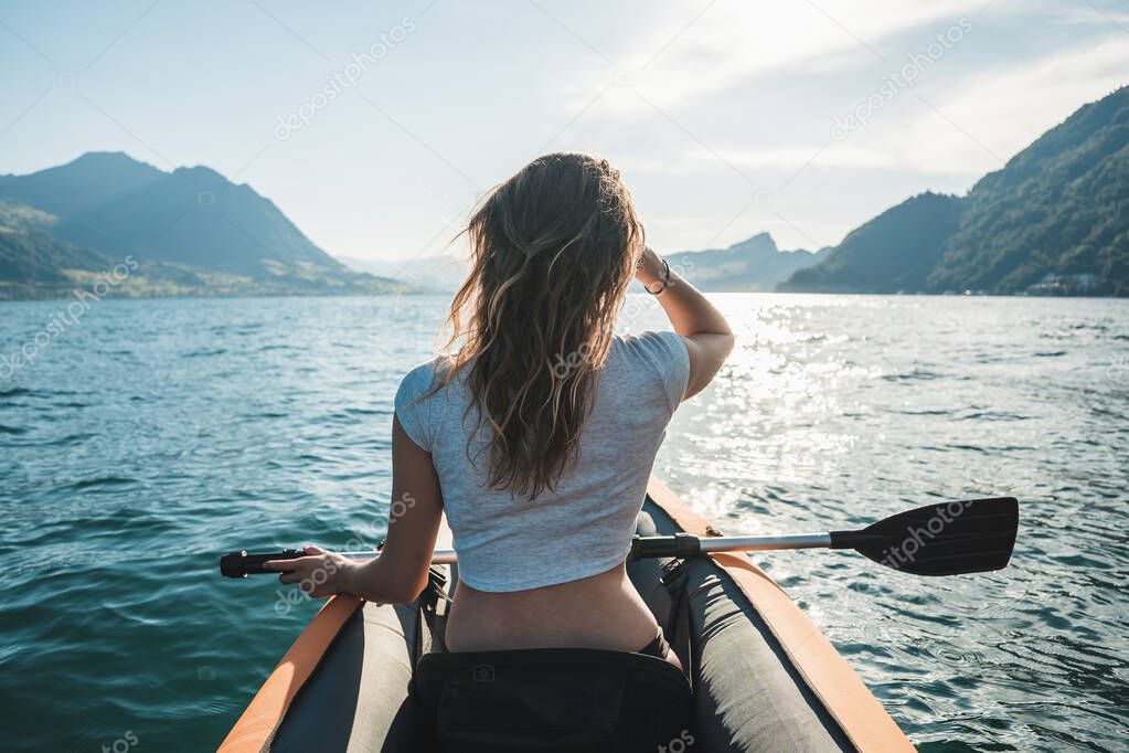 Girl kayaking on a lake in Switzerland