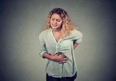 woman hands on stomach and back having bad aches pain clipart
