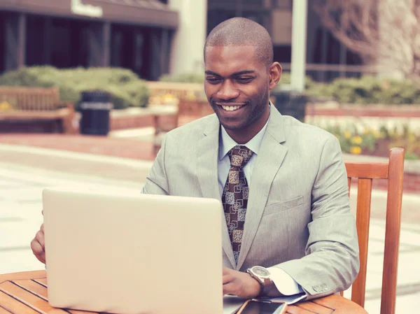 Business man working on his laptop outdoors corporate office — стоковое фото