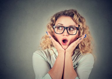 young woman with long hair looking excited surprised 