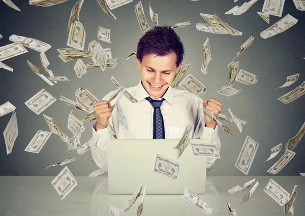 Man using laptop building online business under money rain — Stock Photo, Image