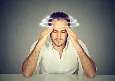 Man with vertigo. Young patient suffering from dizziness. clipart