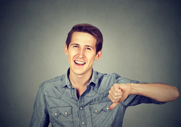 Sarcastic man showing thumbs down, happy someone lost — Stockfoto