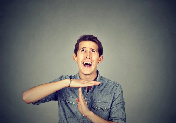 Young man showing time out hand gesture, frustrated screaming — Stock Photo, Image