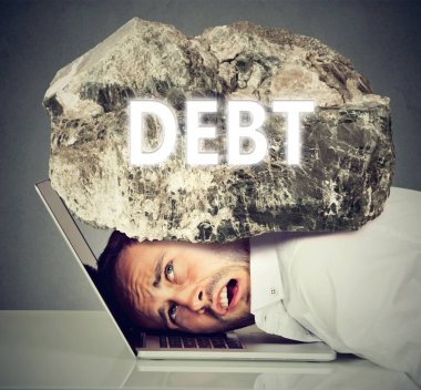man squeezed between laptop and rock. Student loan debt concept clipart