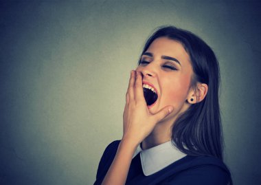 Sleepy woman with wide open mouth yawning looking bored  clipart